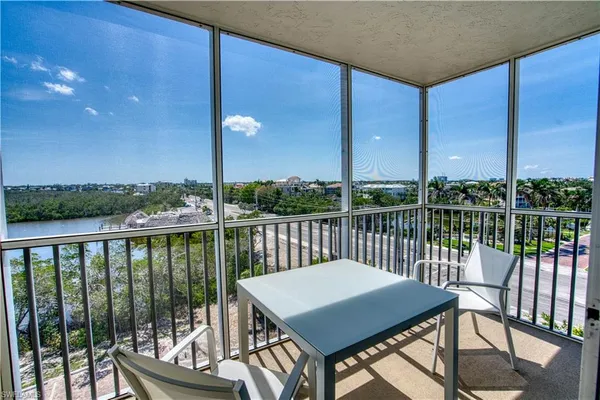 a view of a balcony with lake view and wooden floor