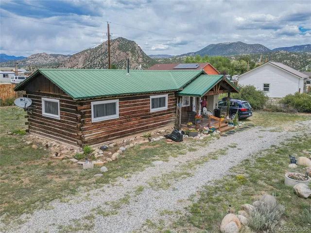 a aerial view of a house with a big yard and potted plants