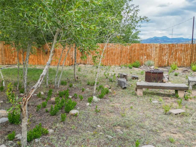 a backyard of a house with table and chairs