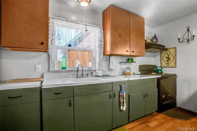 a kitchen with a sink cabinets and window