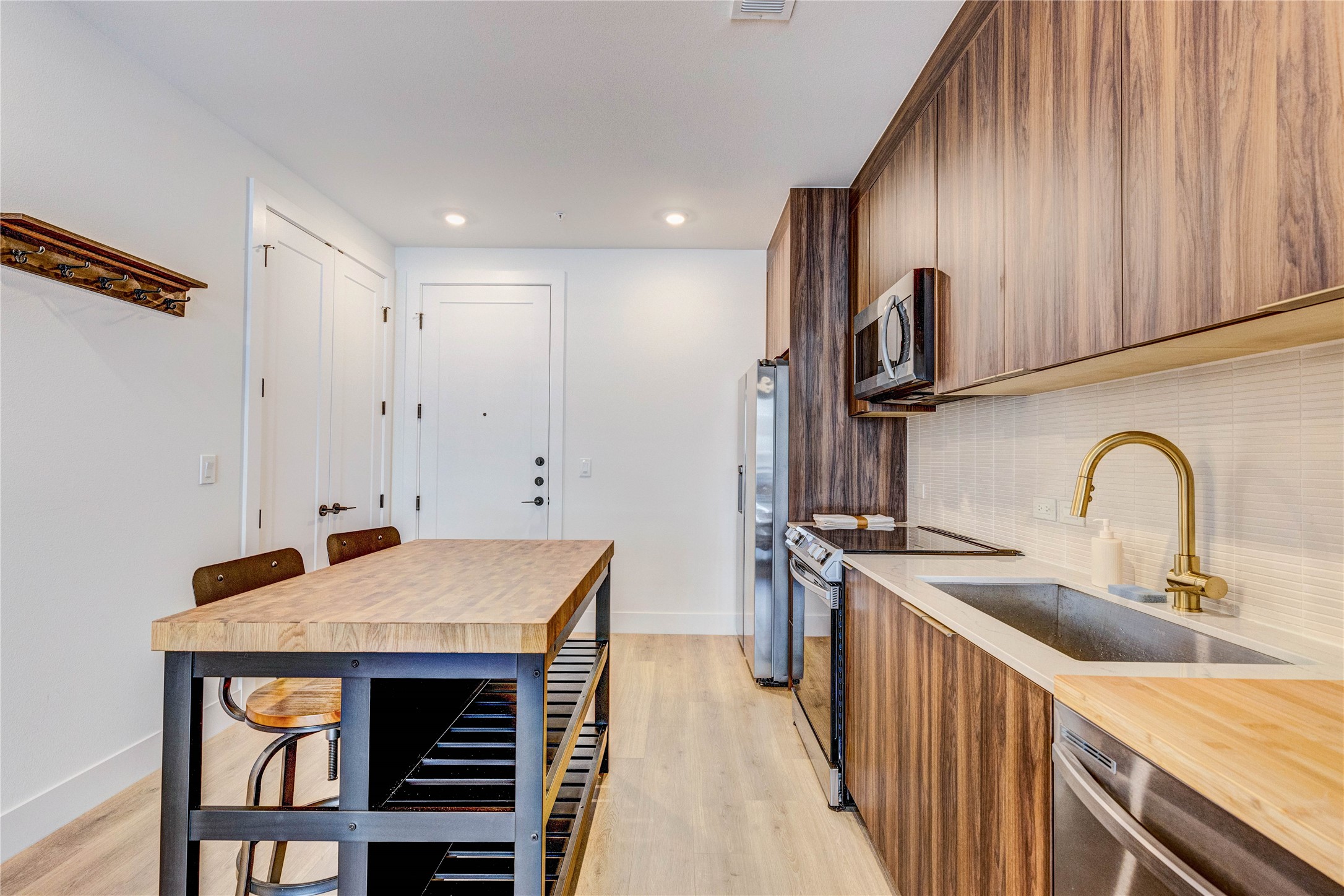 1701 Simond Avenue, Unit 301 Austin, TX 78723 - Photo 13 of 26 a kitchen with stainless steel appliances a table and chairs in it