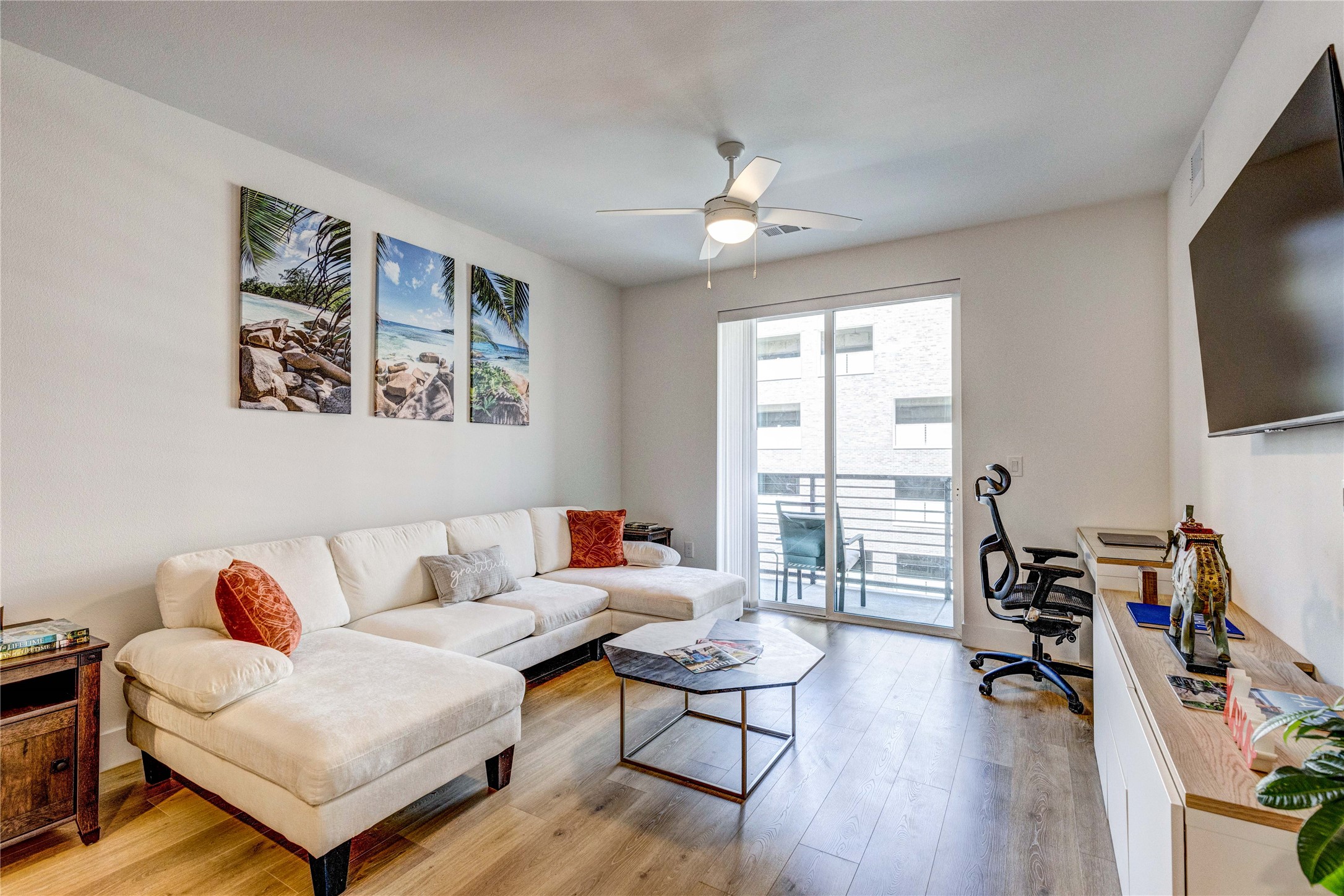 1701 Simond Avenue, Unit 301 Austin, TX 78723 - Photo 2 of 26 a living room with furniture and a flat screen tv