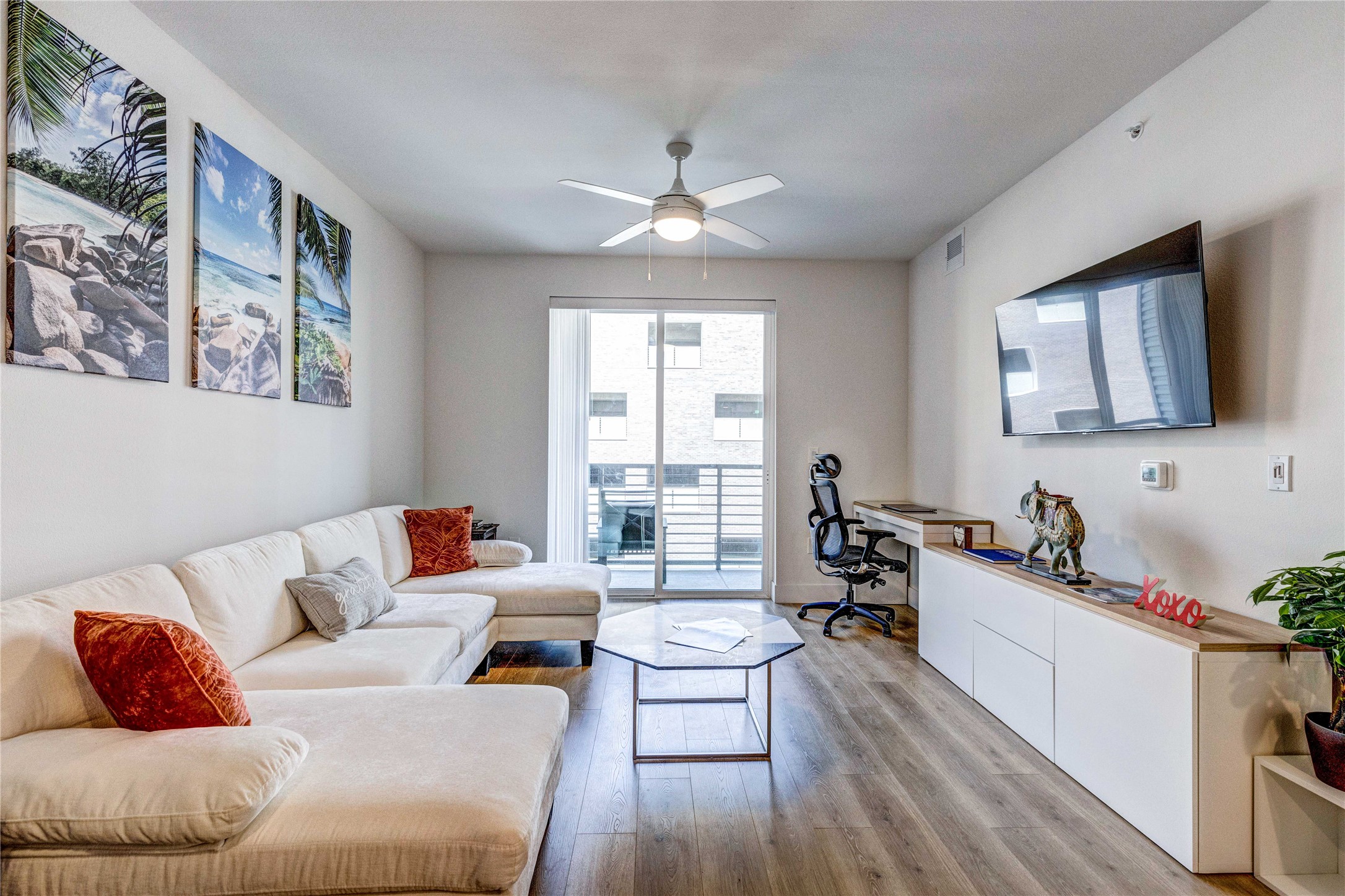 1701 Simond Avenue, Unit 301 Austin, TX 78723 - Photo 4 of 26 a living room with furniture and a flat screen tv