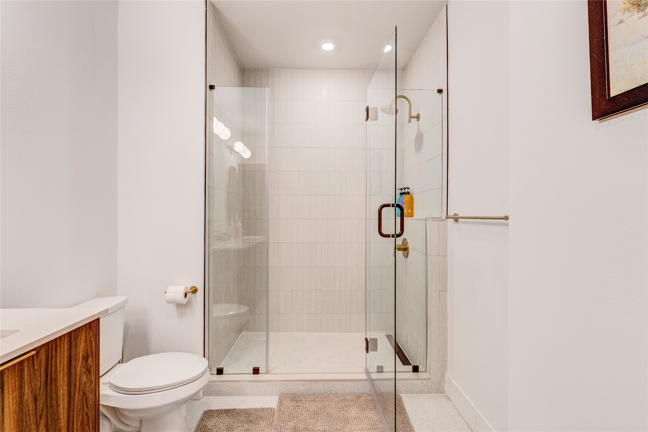 1701 Simond Avenue, Unit 301 Austin, TX 78723 - Photo 10 of 26 a bathroom with a glass shower door