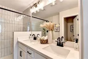 a bathroom with a double vanity sink and a mirror