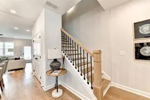 a view of entryway and hall with wooden floor