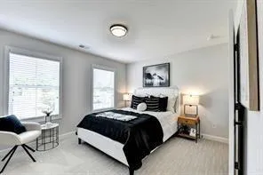 a bedroom with a bed a chair and a window