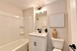 a bathroom with a sink a toilet and bathtub