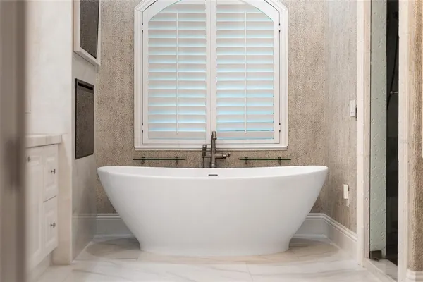 a kitchen with kitchen island granite countertop a sink cabinets and refrigerator