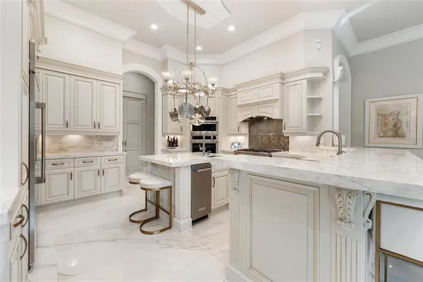 a living room with furniture a chandelier and a fireplace