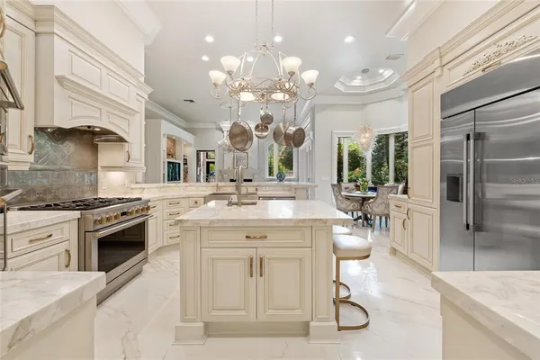 a living room with furniture a chandelier and a chandelier