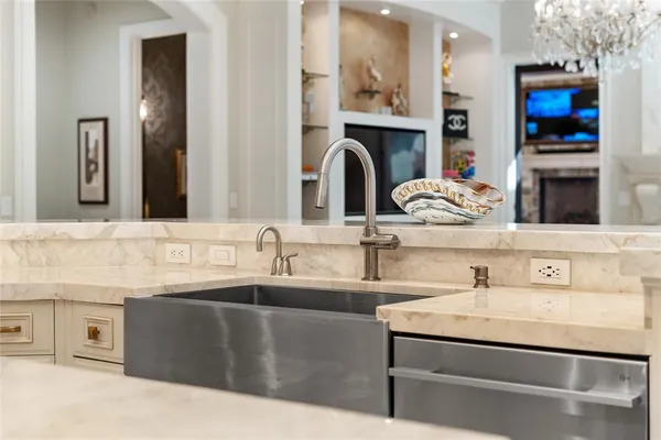 a view of a dining room with furniture a chandelier and wooden floor