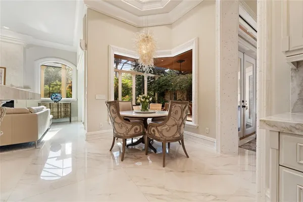 a living room with couches and kitchen view