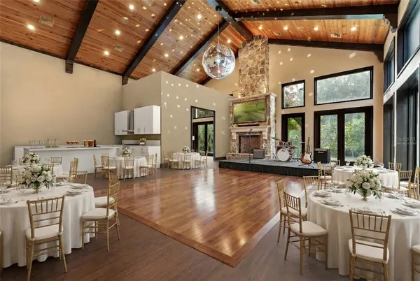 a bedroom with a large bed and a chandelier