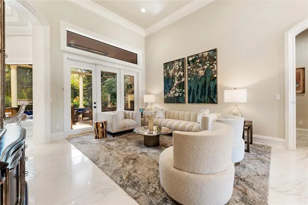 a dining room with furniture a chandelier and wooden floor