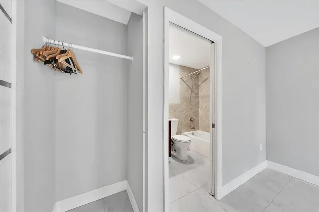 a view of a livingroom with a ceiling fan & wooden floor