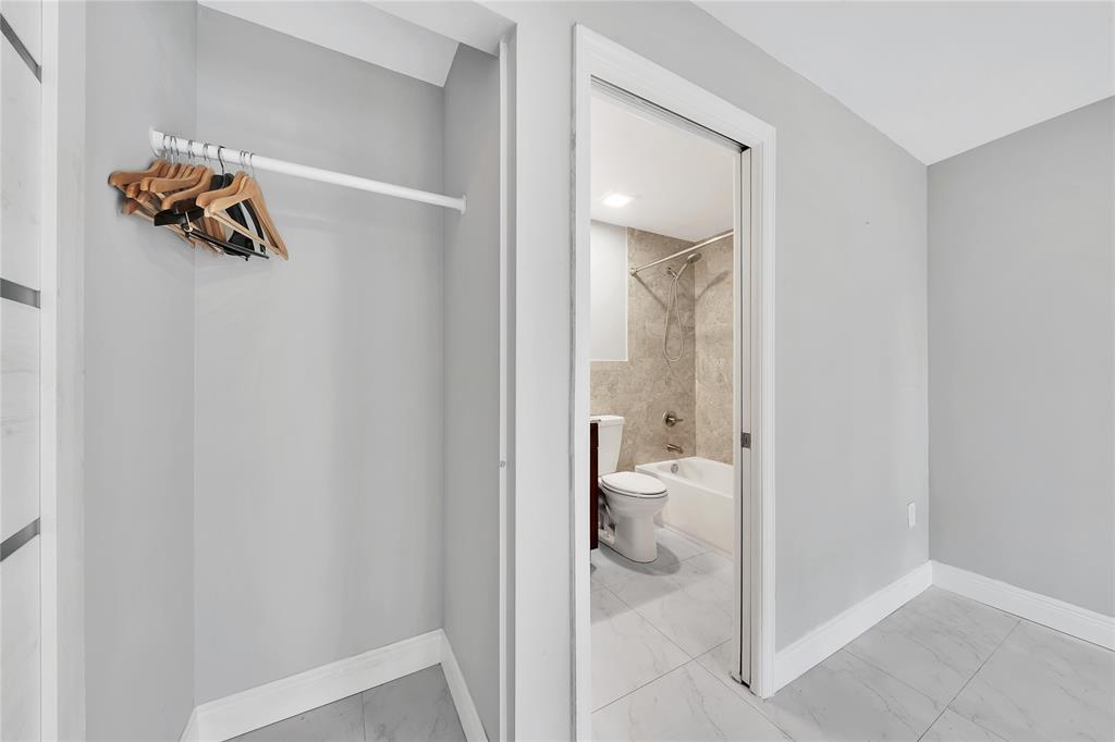 2725 Northeast 8th Avenue, Unit 113 Wilton Manors, FL 33334 - Photo 12 of 72 a bathroom with a toilet and a view of bathroom