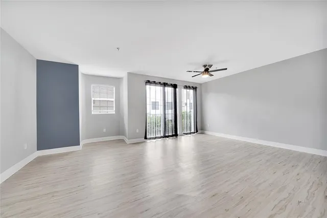 a large kitchen with a lot of counter space and stainless steel appliances