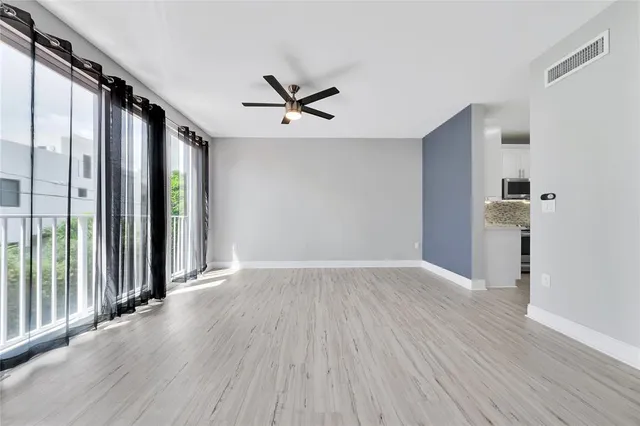 a large kitchen with stainless steel appliances granite countertop a stove and a sink