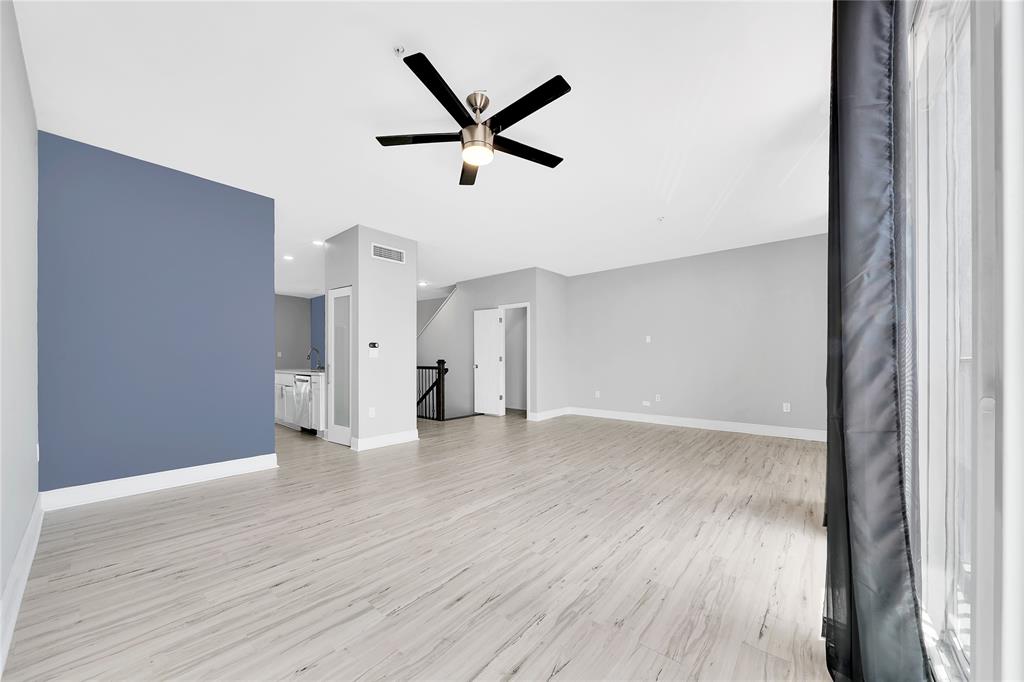 2725 Northeast 8th Avenue, Unit 113 Wilton Manors, FL 33334 - Photo 17 of 72 a view of a livingroom with a ceiling fan & wooden floor