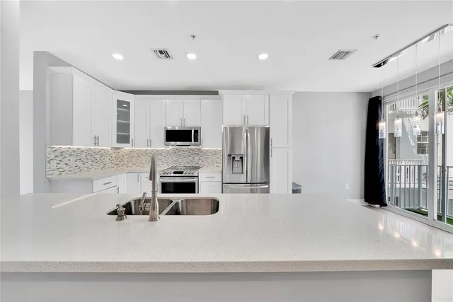a view of a living room and kitchen with furniture