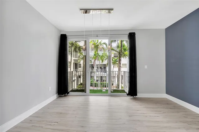 a view of a hallway with wooden floor and stairs