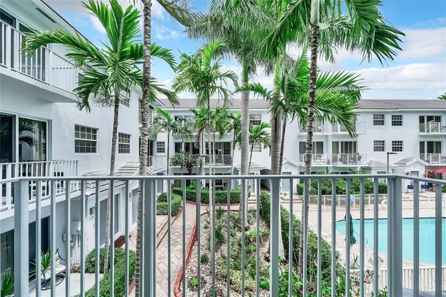 a view of a hallway to a kitchen with windows