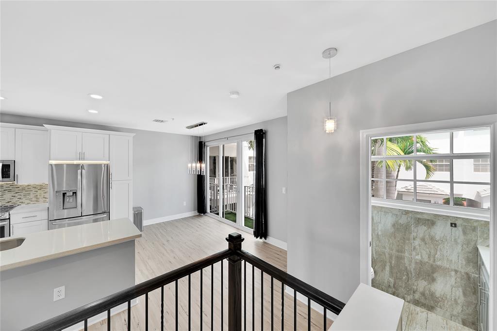 2725 Northeast 8th Avenue, Unit 113 Wilton Manors, FL 33334 - Photo 33 of 72 a view of a hallway to a kitchen with windows
