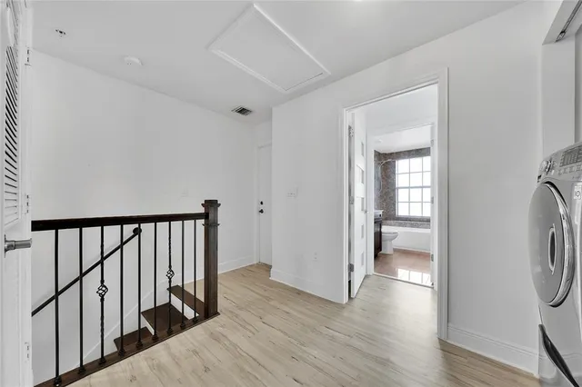 a very nice looking room with a large window and wooden floors