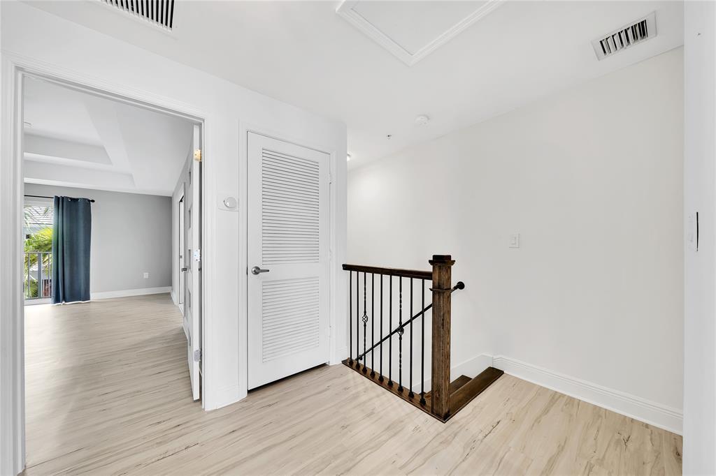 2725 Northeast 8th Avenue, Unit 113 Wilton Manors, FL 33334 - Photo 37 of 72 a view of a hallway with wooden floor