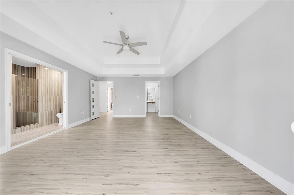 2725 Northeast 8th Avenue, Unit 113 Wilton Manors, FL 33334 - Photo 40 of 72 a view of empty room with wooden floor and fan