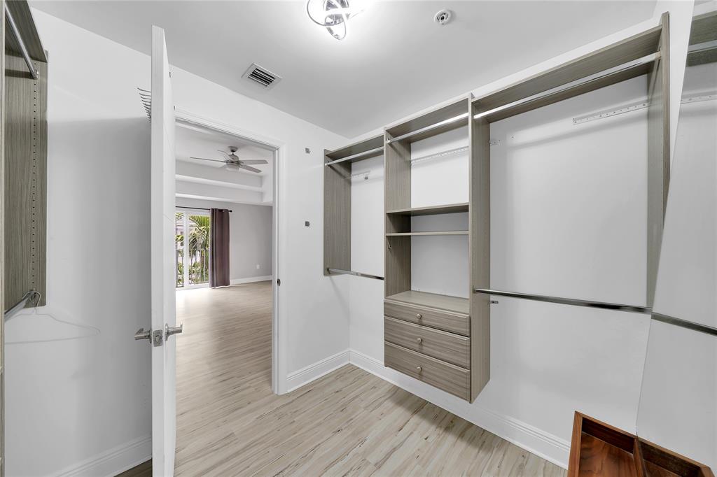 2725 Northeast 8th Avenue, Unit 113 Wilton Manors, FL 33334 - Photo 46 of 72 a view of walk in closet with empty racks