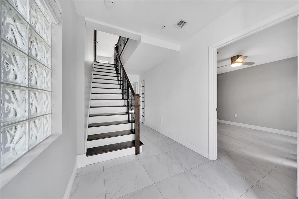 2725 Northeast 8th Avenue, Unit 113 Wilton Manors, FL 33334 - Photo 5 of 72 a view of a livingroom with wooden floor and stairs