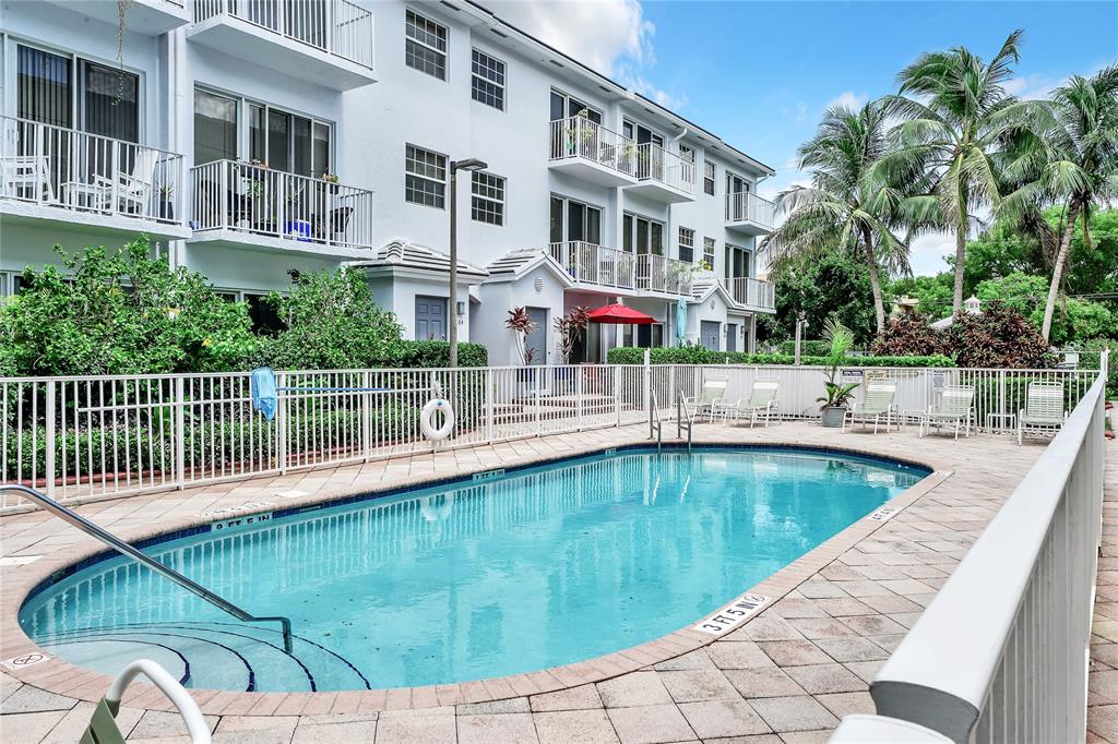 2725 Northeast 8th Avenue, Unit 113 Wilton Manors, FL 33334 - Photo 61 of 72 a view of a swimming pool with a balcony