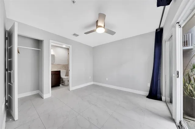 a bathroom with a toilet and a view of bathroom