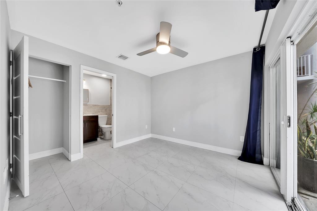 2725 Northeast 8th Avenue, Unit 113 Wilton Manors, FL 33334 - Photo 8 of 72 a view of an empty room with a fireplace