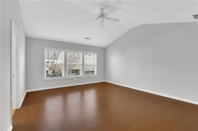 a spacious bathroom with a shower a sink and a mirror
