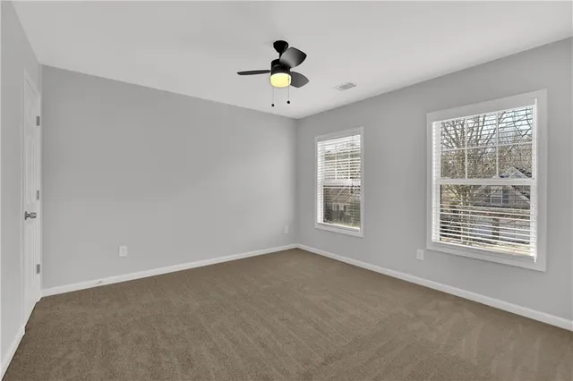 an aerial view of a house with a yard and lake view