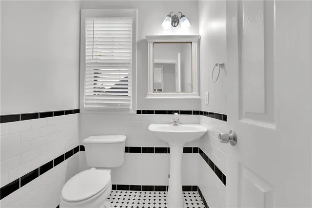 a bedroom with a bed a chandelier and a window