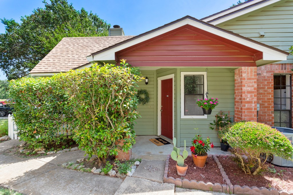 a front view of a house with plants