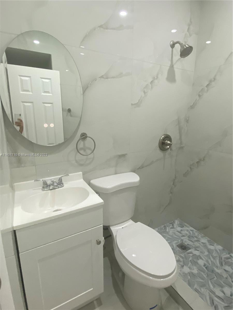 429 Southwest 7th Avenue Homestead, FL 33030 - Photo 12 of 16 a bathroom with a toilet sink and mirror