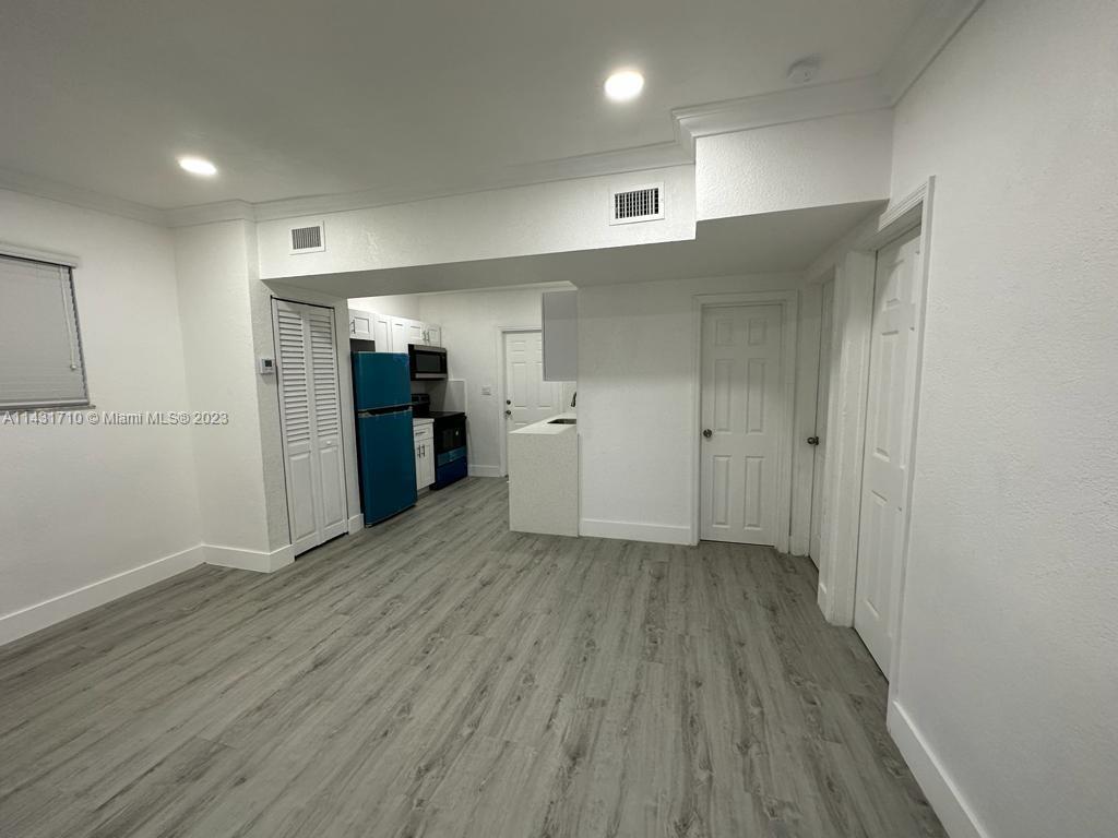 429 Southwest 7th Avenue Homestead, FL 33030 - Photo 3 of 16 wooden floor in an empty room with an empty room