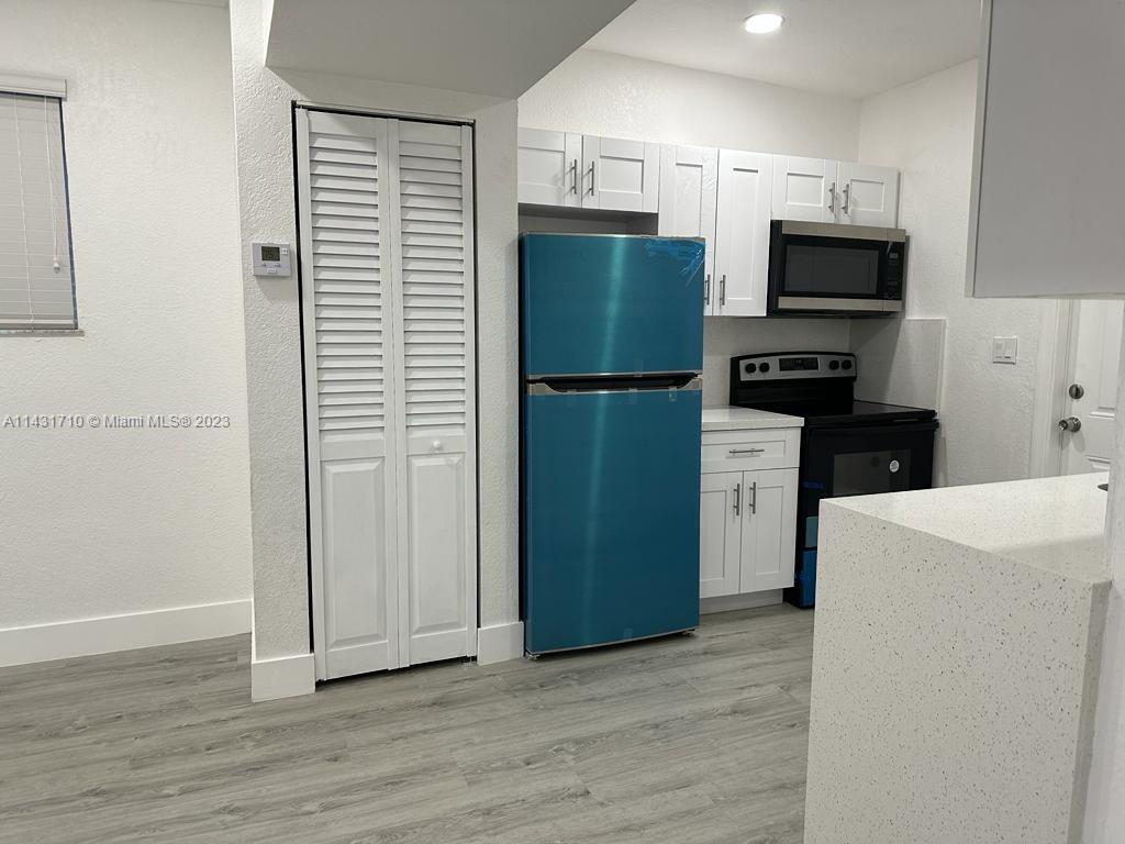 429 Southwest 7th Avenue Homestead, FL 33030 - Photo 4 of 16 a kitchen with stainless steel appliances a refrigerator and a stove top oven