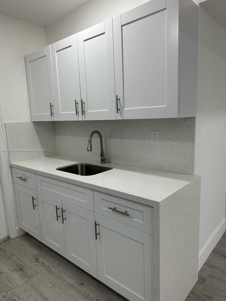 429 Southwest 7th Avenue Homestead, FL 33030 - Photo 7 of 16 a kitchen with white cabinets
