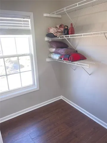 a view of a closet with white walls