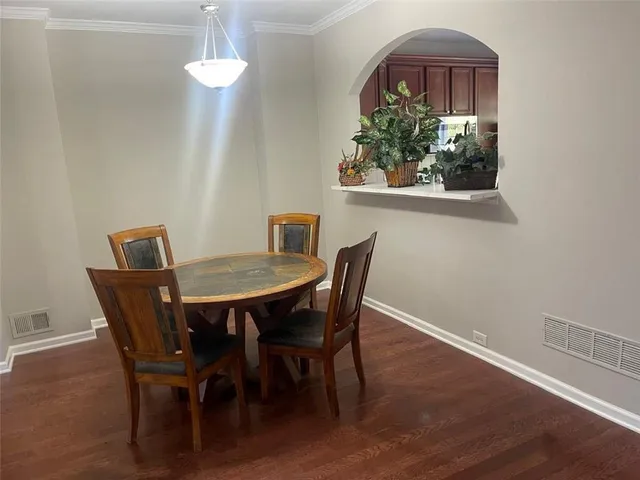 a view of a dining room with furniture wooden floor and a chandelier
