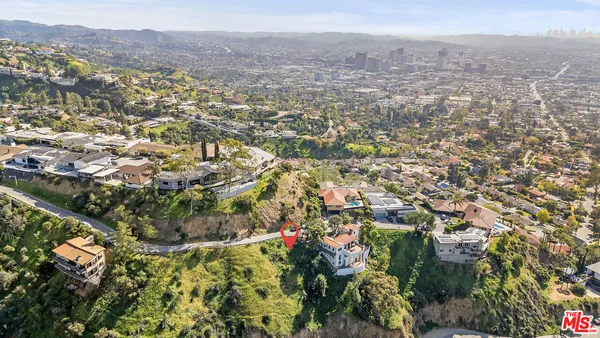 an aerial view of residential house and tree