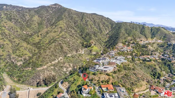 an aerial view of residential house with green space