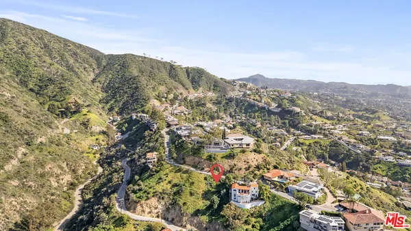 an aerial view of residential house with outdoor space and trees