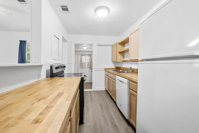 a view of kitchen with sink and cabinets